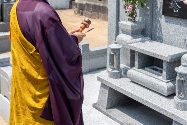 A monk praying in front of the tomb A monk praying in front of the tomb